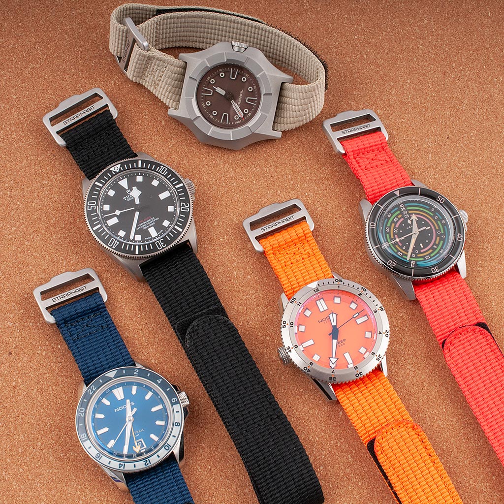 Five watches on hook-and-loop single-pass straps in khaki, navy, black, orange, and red with StrapHabit buckles