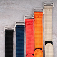 Hook-and-loop single-pass watch straps in all five colors with StrapHabit branded buckles, flat lay