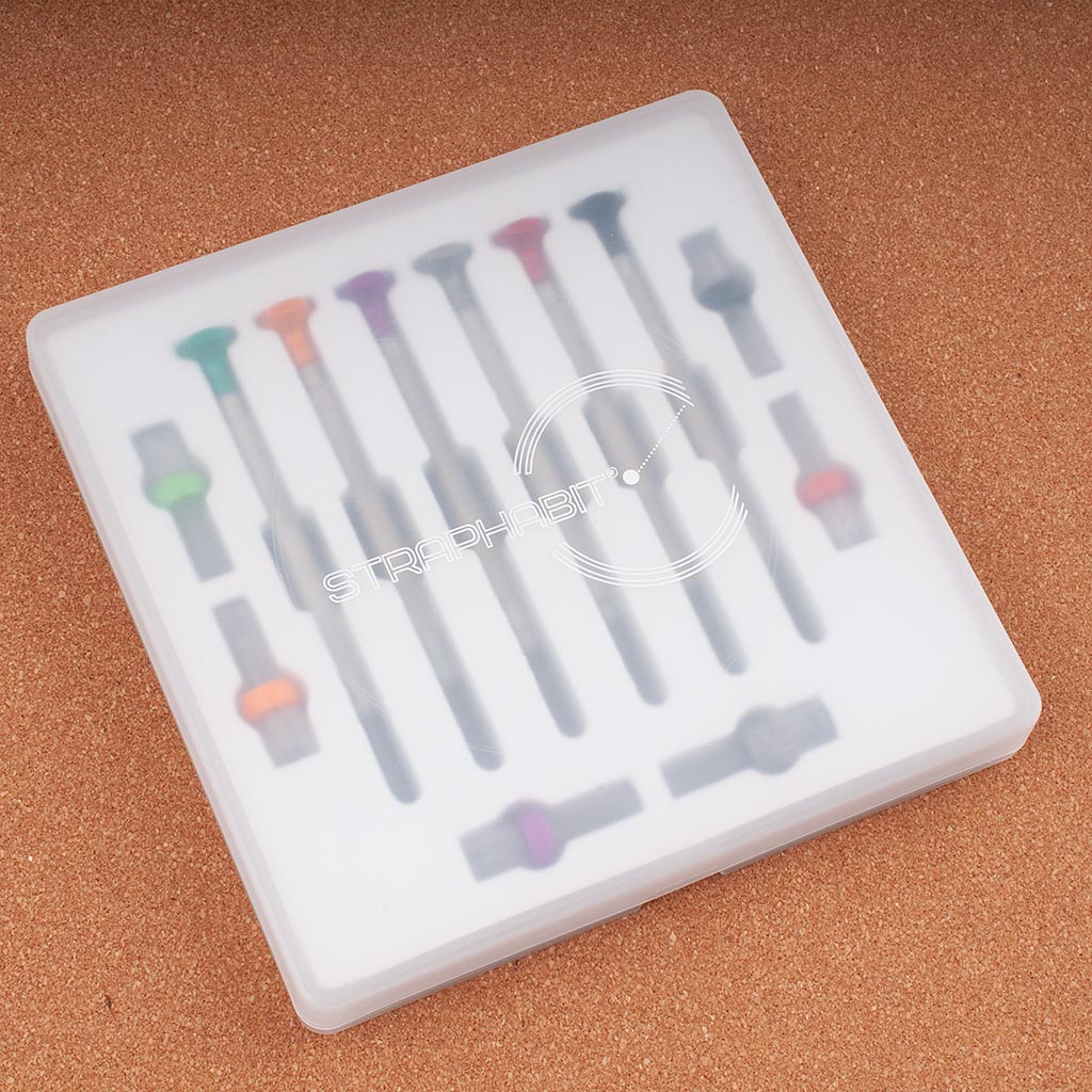 StrapHabit Mini Watch Screwdriver Pro Kit in clear-lidded carrying case showing the full set of precision screwdrivers and bits organized in a white tray