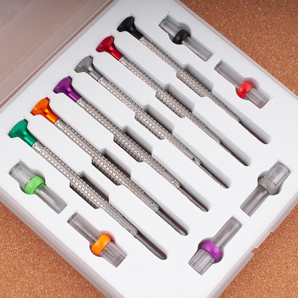 StrapHabit Mini Watch Screwdriver Pro Kit with color-coded precision screwdrivers and interchangeable bits in a fitted white storage tray